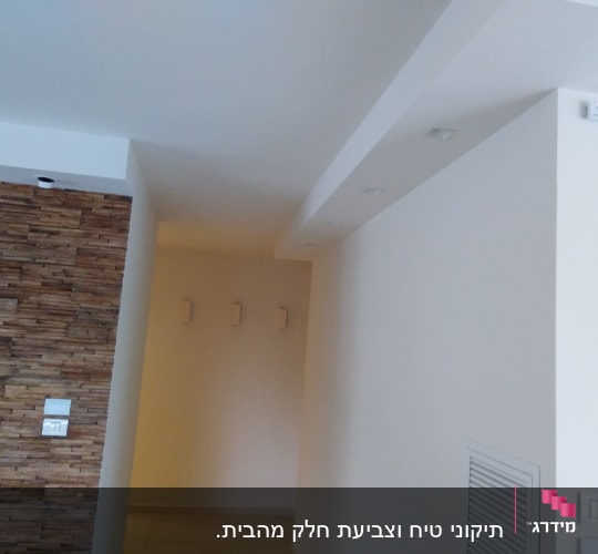 קיר צבוע בלבן עם תאורה שקועה